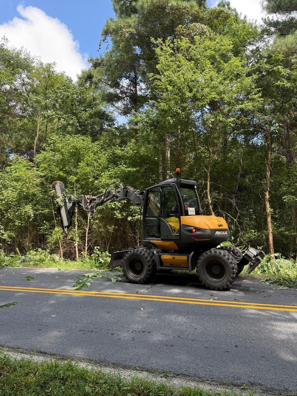 MTM Enterprises equipment clearing vegetation along a roadway
